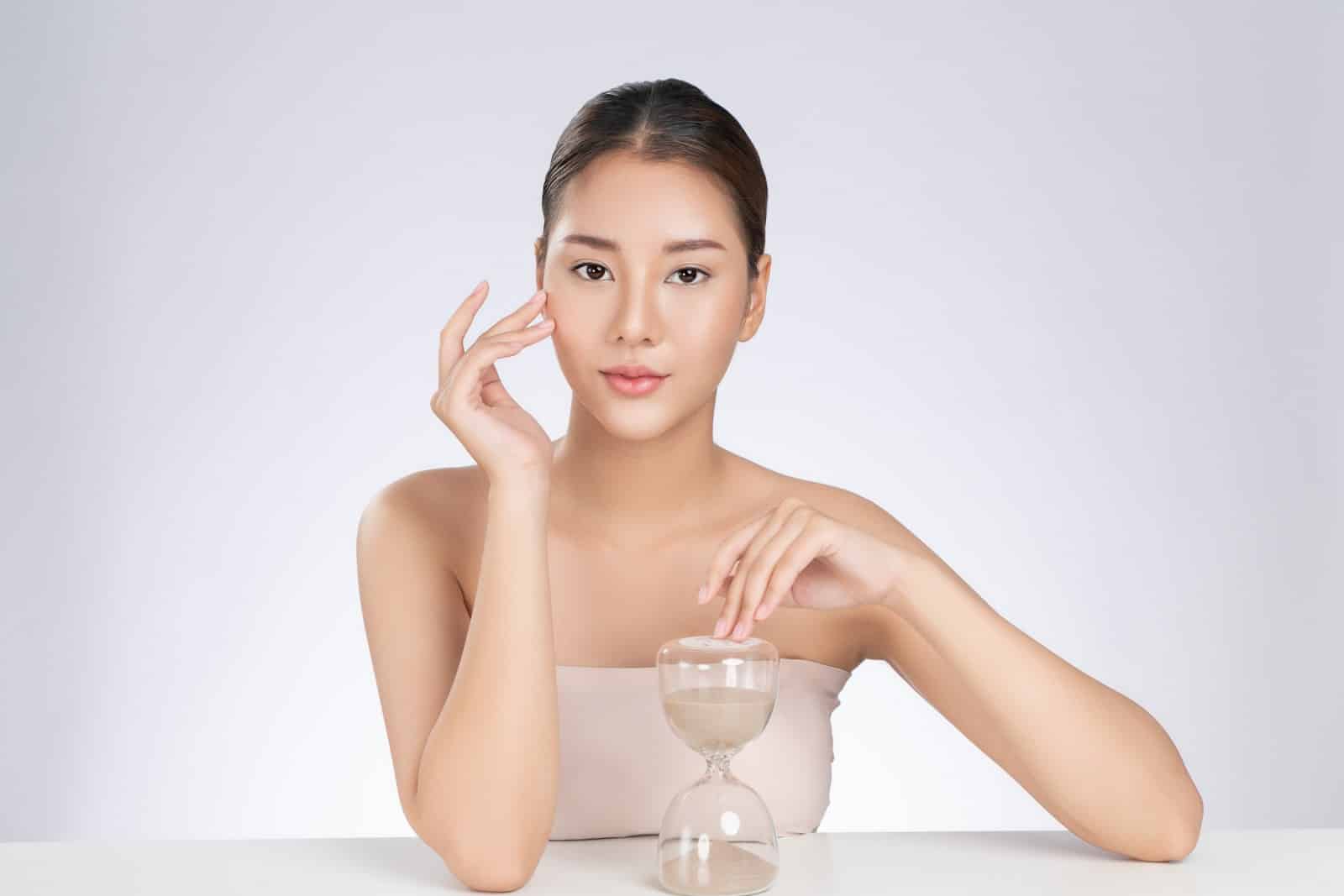 beautiful Asian woman with food hourglass biological aging clock_1600x1067 hourglass biological aging clock little man